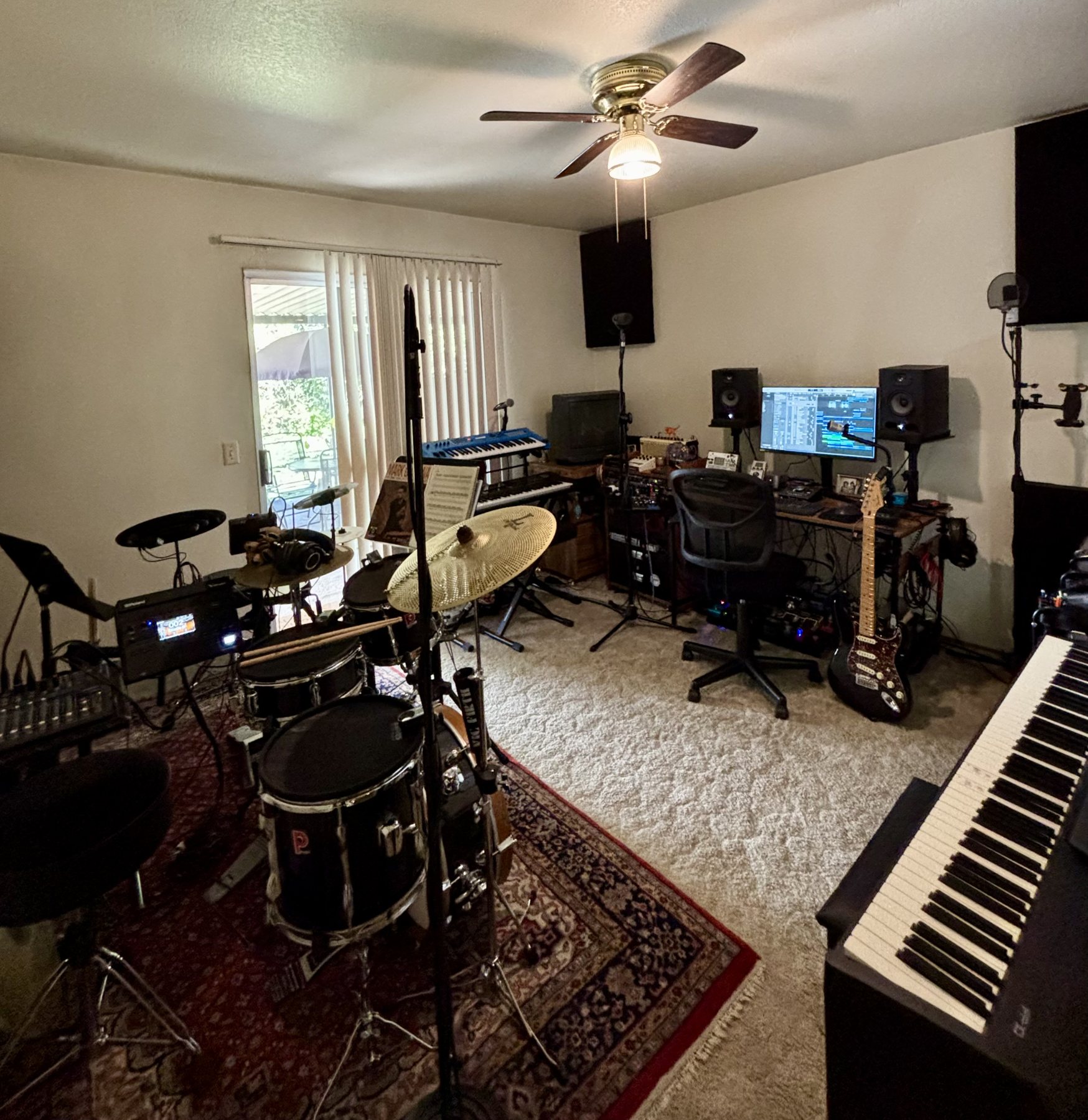 Blackburn Music Studio with drums, keyboards, guitar, and recording workstation